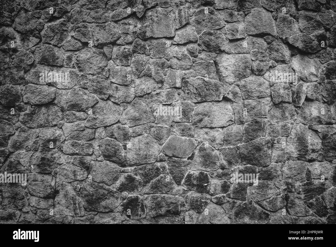 Astratto parete tradizionale pietra pavimentazione sfondo texture. Pietra ruvida testurizzata realizzata in pietra d'agugne e slabstone. Foto Stock