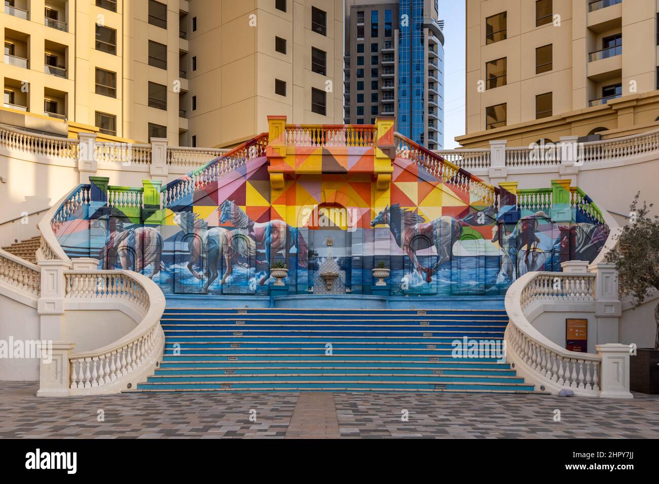 Un mare di cavalli, murale di cavalli galoppanti su scala nella zona di Dubai Marina, Emirati Arabi Uniti. Foto Stock