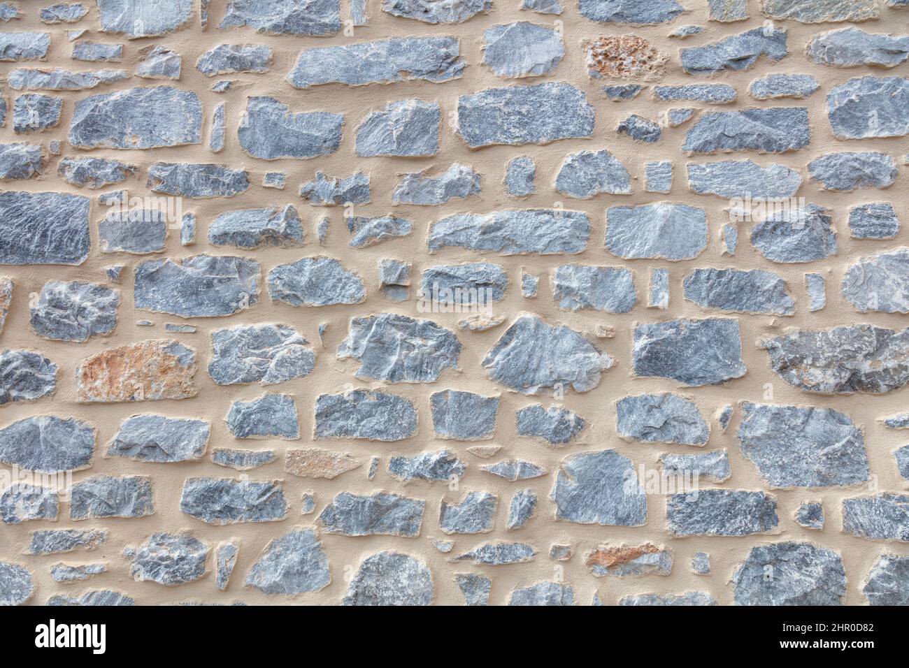 Pietra parete texture sfondo. Vecchia facciata tradizionale in pietra, materiale naturale per rivestimenti e pavimenti Foto Stock