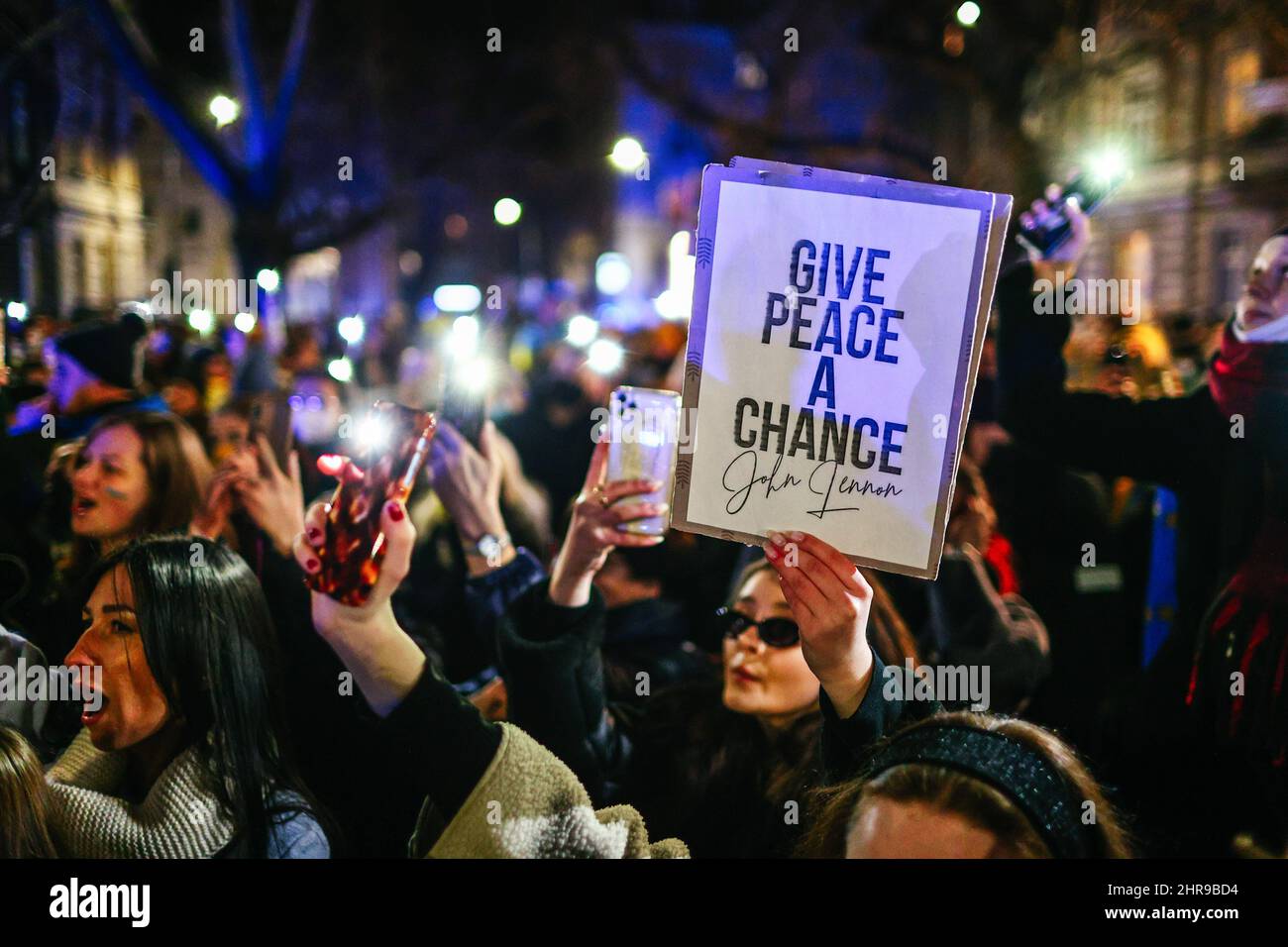 Un manifestante ha visto tenere un cartello con una citazione di John Lennon 'dare la pace una chance' durante la manifestazione. Dopo l'inizio dell'invasione russa dell'Ucraina, membri della comunità Ucraina e polacchi e bielorussi di sostegno hanno protestato presso le missioni diplomatiche della Federazione russa per esprimere la loro opposizione all'aggressione militare russa. A Cracovia, dove l'immigrazione Ucraina è particolarmente numerosa, diverse migliaia di persone si sono radunate davanti al consolato russo. (Foto di Filip Radwanski / SOPA Images/Sipa USA) Foto Stock
