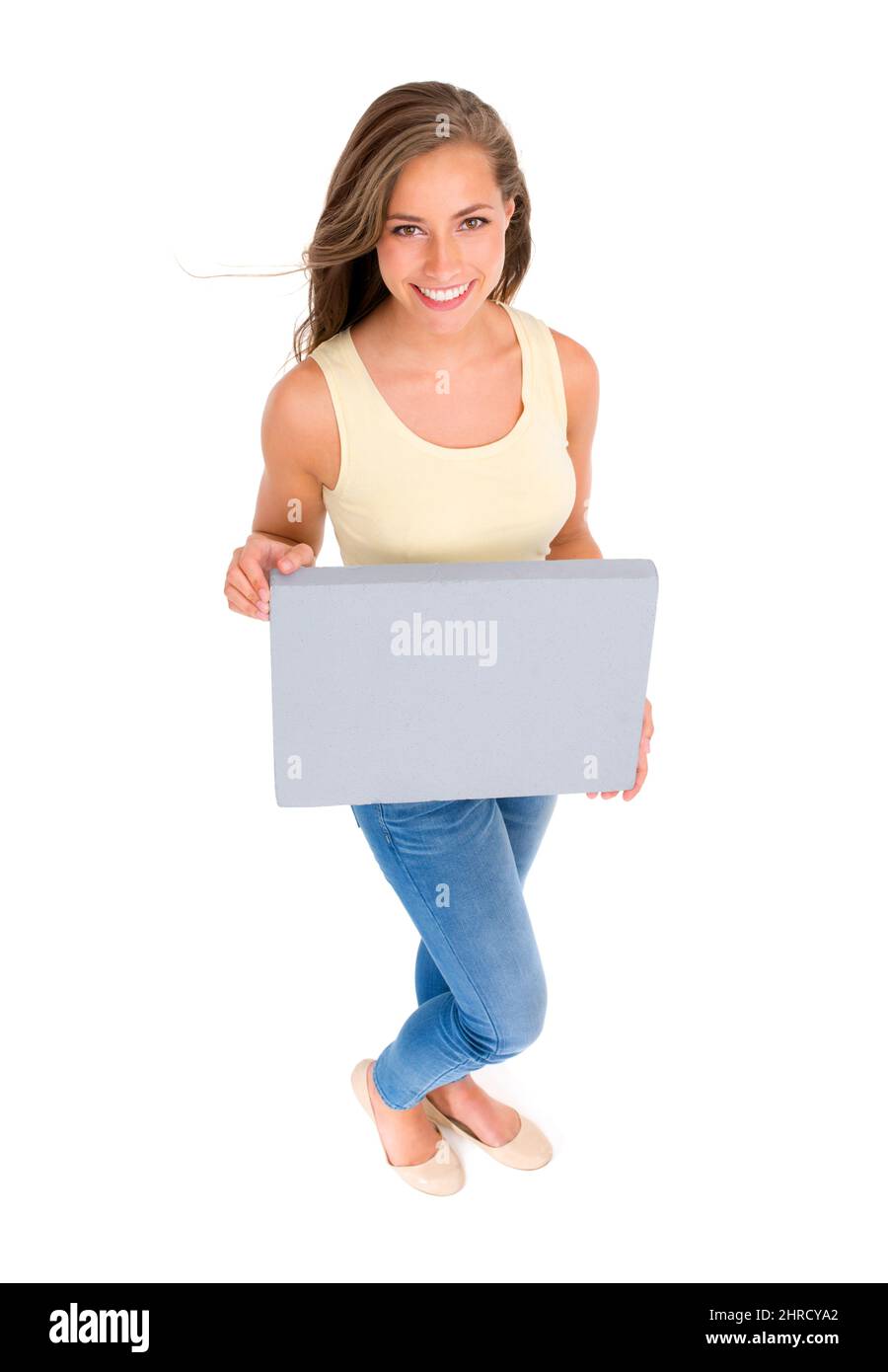 Shes ha ottenuto una fiducia casuale su di lei. Scatto ad angolo alto di una bella giovane donna che tiene un cartello bianco su sfondo bianco. Foto Stock