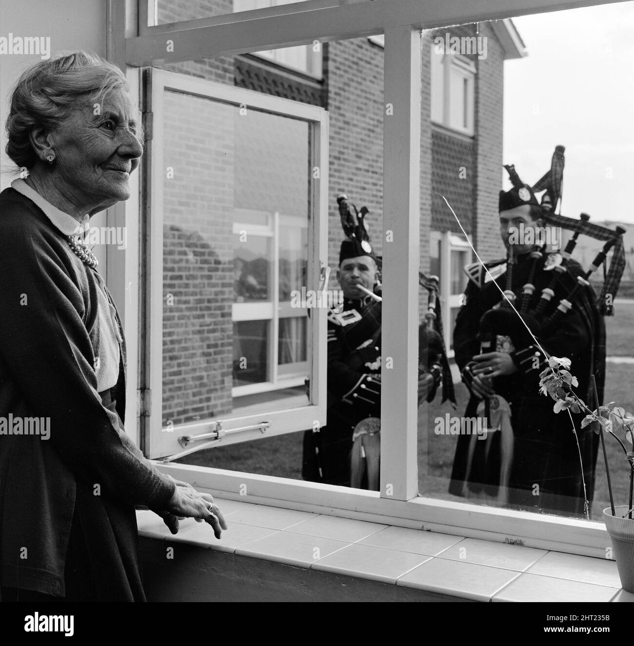 A causa di una richiesta speciale, Sgt. John Gibb (ex Black Watch Guard) e CPL. Glyn Pritchard (ex Queens Own Cammeron Highlanders) gioca cornamuse a Daisy Round (89) alla Old Folks Home di Beacon View, Skelmersdale, Lancashire 6th marzo 1966. *** Local Caption *** Old PeopleSenior Citizens OAP Women Foto Stock