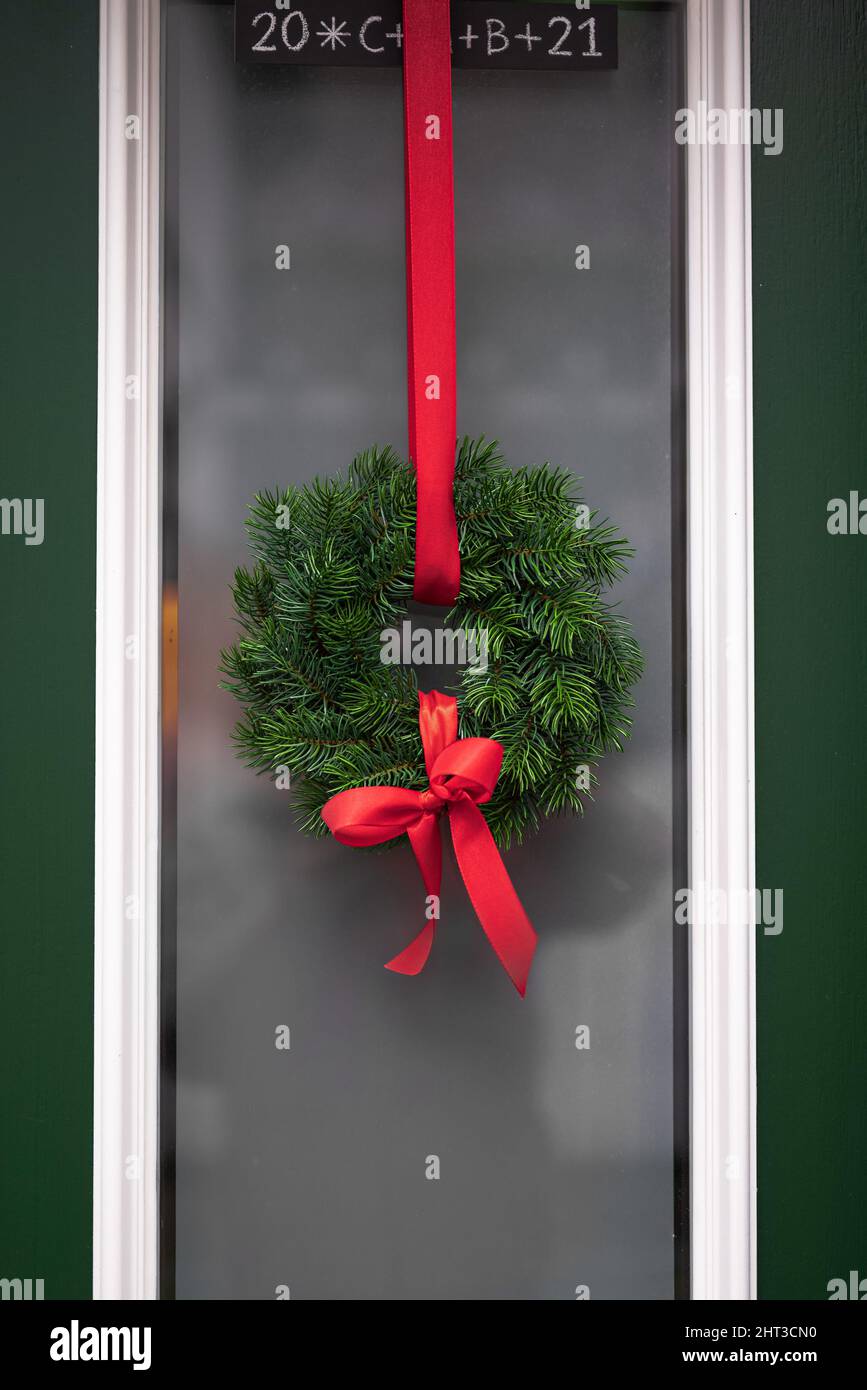 Un colpo verticale delle ghirlande di Natale appese alla porta Foto Stock