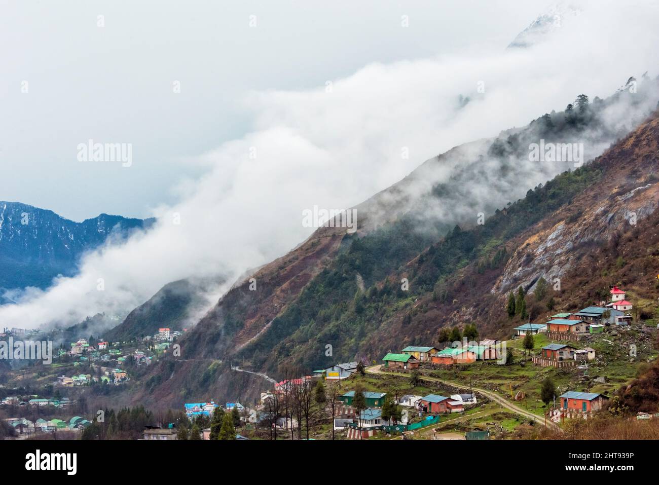 Villaggio di Lachung nella valle di montagna coperta di nebbia, Sikkim, India Foto Stock