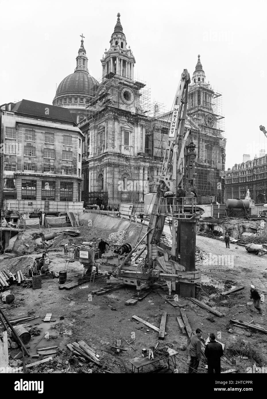 St Paul's Cathedral, St Paul's Churchyard, City of London, 01/10/1963. Un carro di perforazione McKinney DAG 60 in funzione durante la costruzione dello sviluppo di Paternoster, con l'estremità occidentale della Cattedrale di St Paul sullo sfondo. I lavori sullo sviluppo di Paternoster sono stati condotti in una joint venture da John Laing Construction Limited, Trollope and Colls Limited e George Wimpey and Company Limited. Lo schema prevedeva la riqualificazione di un sito di sette acri sul lato nord della Cattedrale di St Paul&#x2019. Il sito era stato quasi interamente devastato durante un raid incendiario nel dicembre 1940 Foto Stock