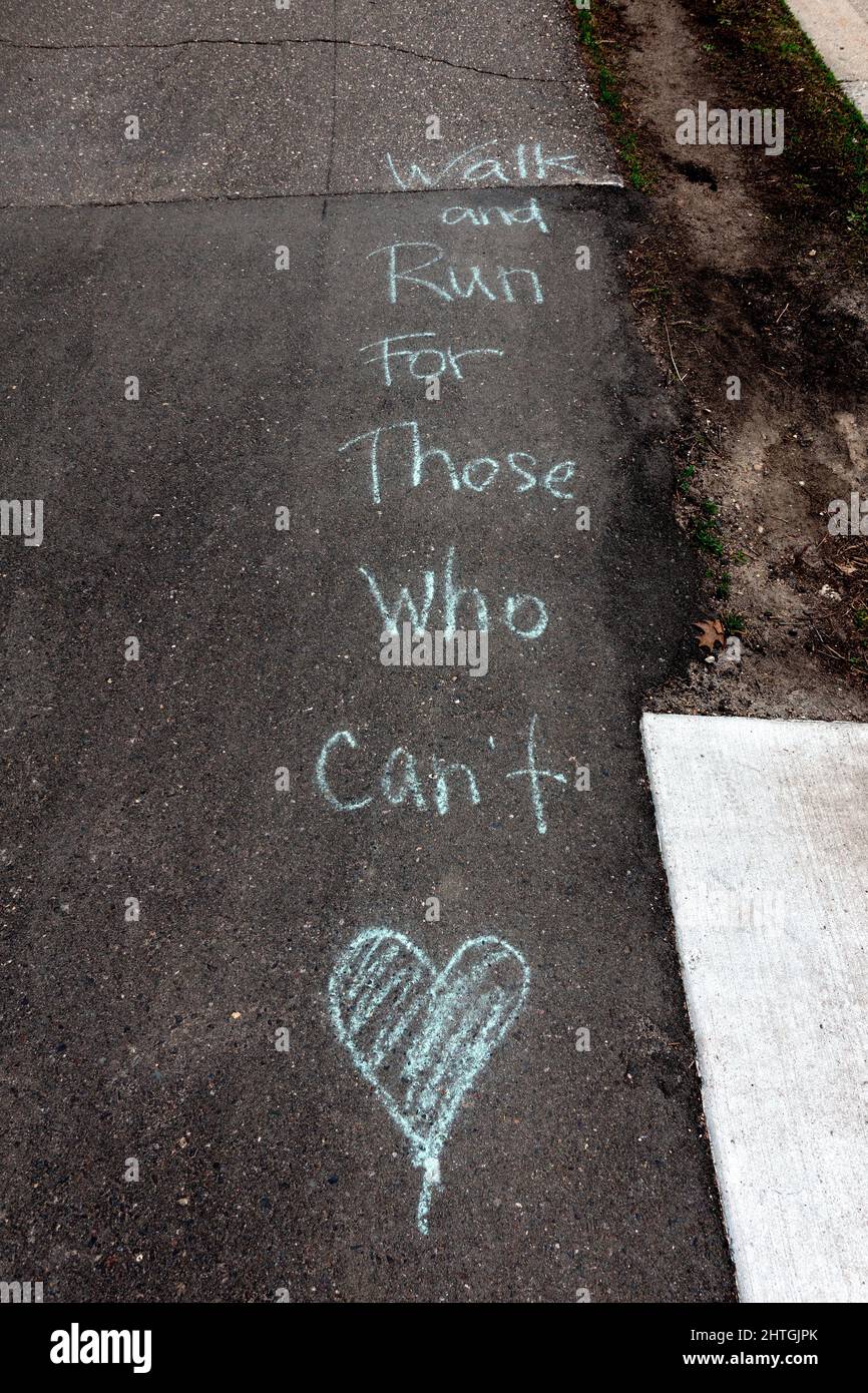 Chalk scrivere per strada circa camminare e correre riconoscendo coloro che non possono. St Paul Minnesota, Stati Uniti Foto Stock
