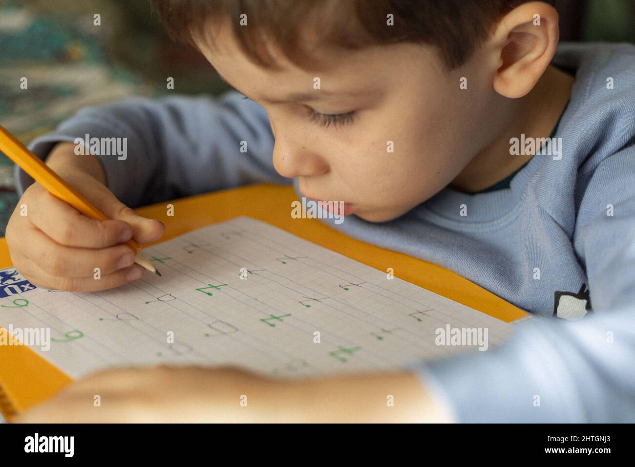 toddler che fa i compiti scrivendo le lettere ed i numeri nel taccuino Foto Stock