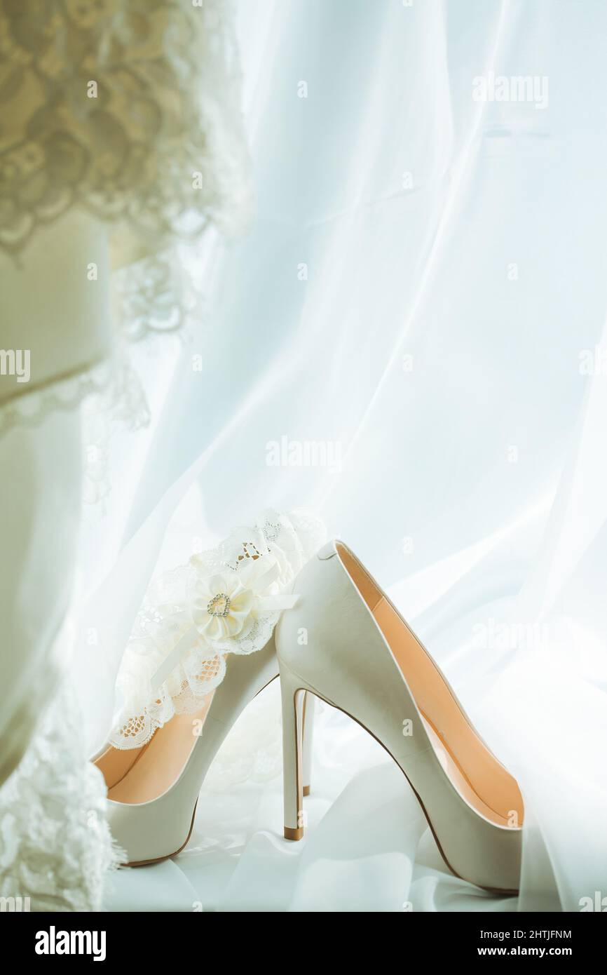 Composizione di scarpe alte beige tallonate poste sul velo da sposa Foto  stock - Alamy