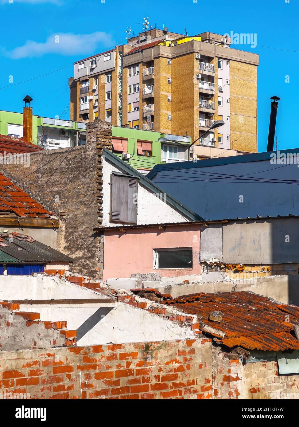 La baraccopoli del quartiere è un decadimento urbano con il cielo blu sullo sfondo Foto Stock