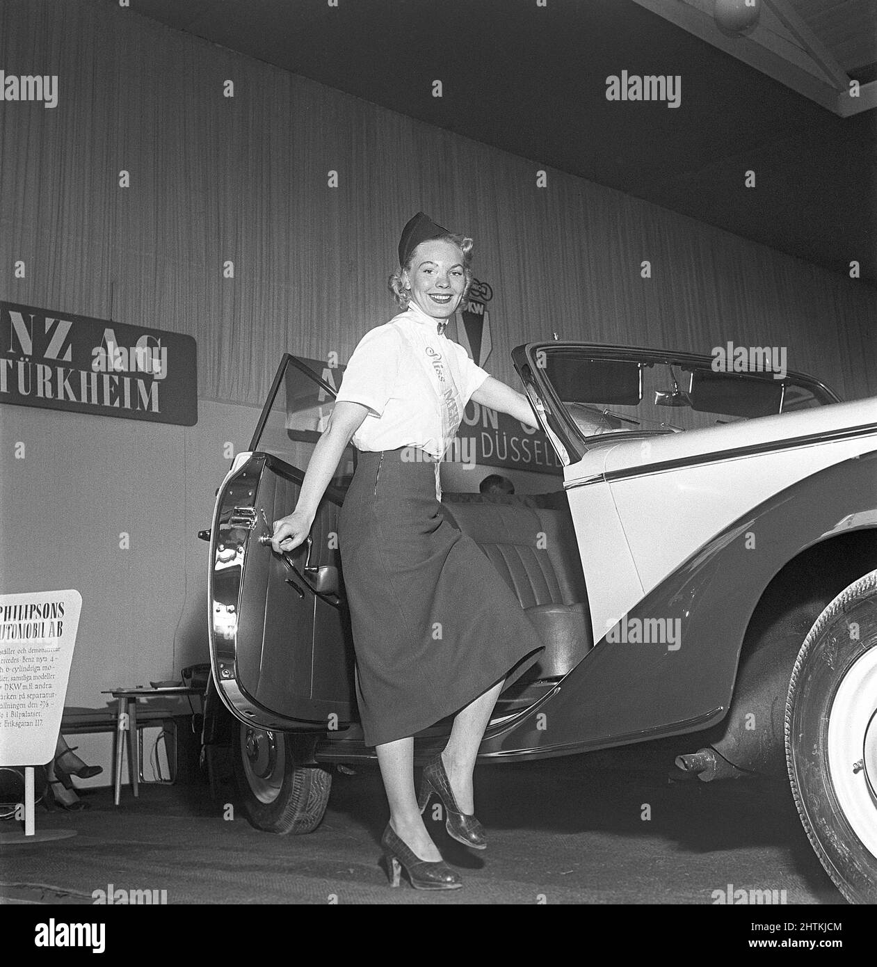 Nel 1950s. Una giovane donna che lavora nell'area Mercedes di una fiera si trova a metà strada in una Mercedes-Benz modell 170 S una vettura convertibile a due posti. Svezia 1951 Kristoffersson Ref BD38-5 Foto Stock