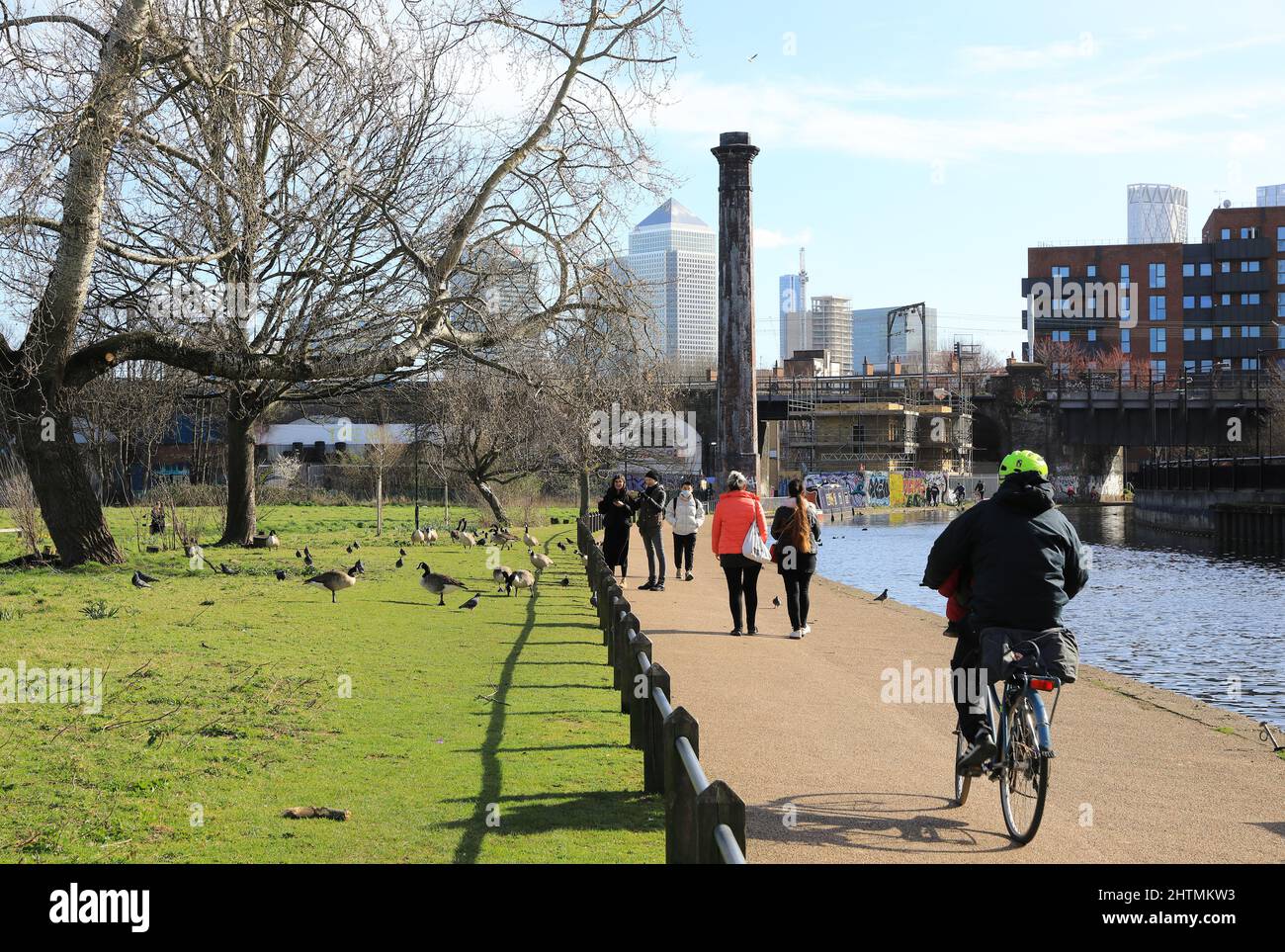 Mile End Park by Regents Canal al sole invernale con Canary Wharf Beyond, nella zona est di Londra, Regno Unito Foto Stock