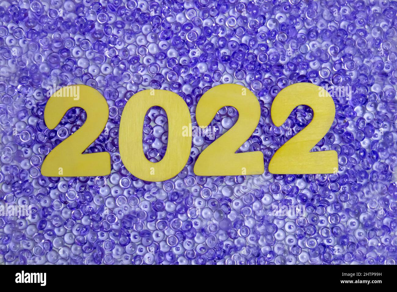 2022 è scritto in numeri di legno su perle viola. Foto Stock