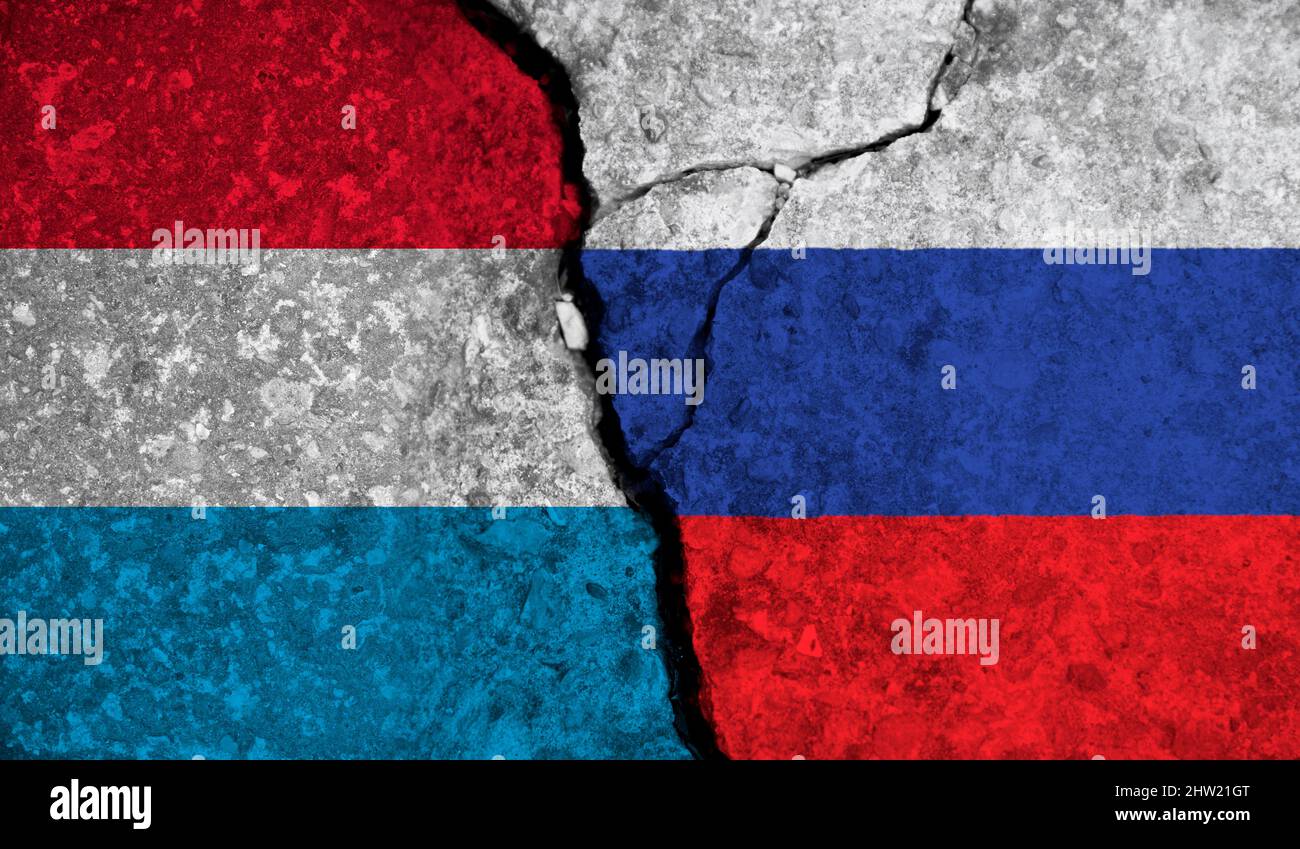 Relazioni politiche tra Lussemburgo e russia. Bandiere nazionali su fondo di cemento fessurato Foto Stock