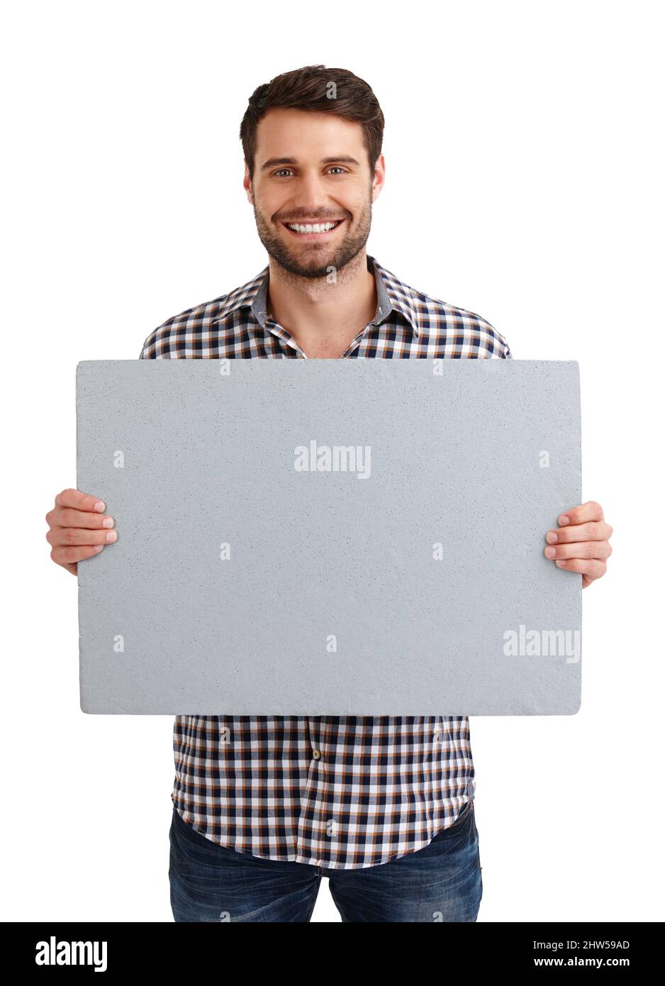 Questo è perfetto. Ritratto da studio di un bel giovane uomo che tiene un cartello bianco isolato su bianco. Foto Stock