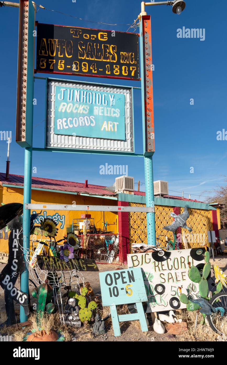 Un segno alto in verità o conseguenze, New Mexico, di fronte ad un negozio di Thrift che vende gli articoli usati dice: Junkology, Rocks, reliquie, Records, Art Foto Stock