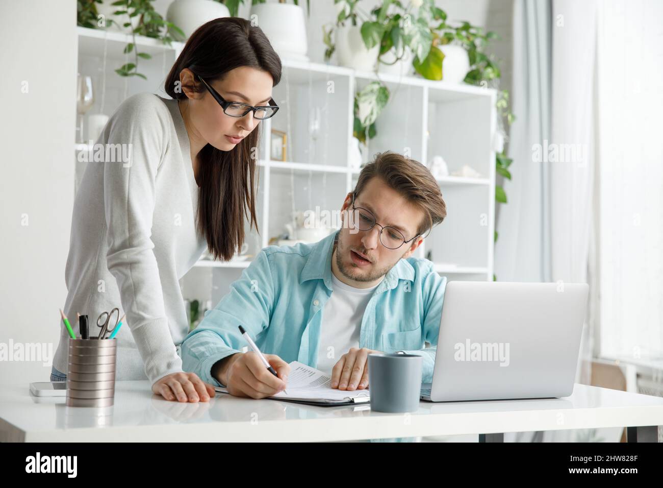 Un uomo e una donna lavorano in un ufficio. Foto Stock