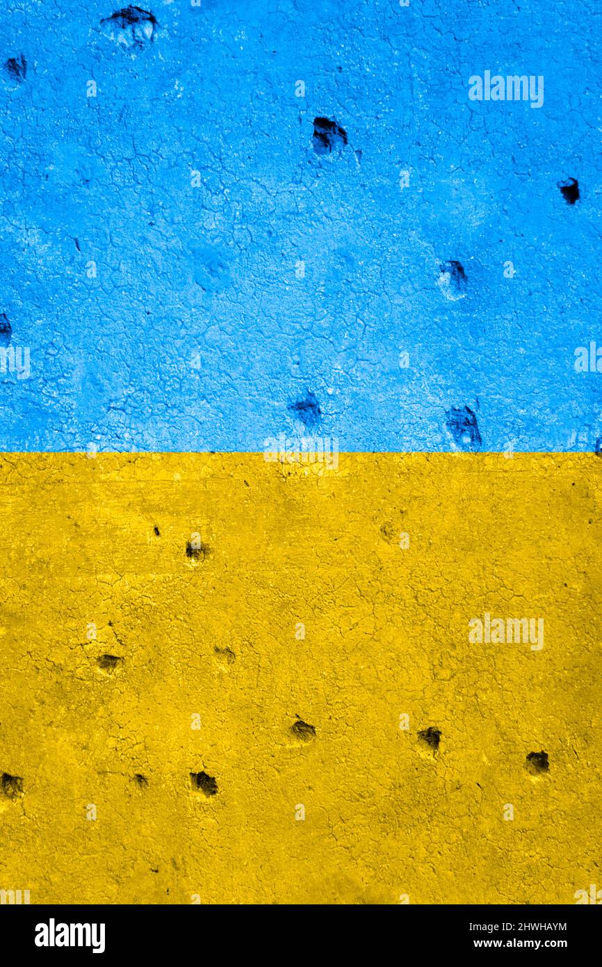 Proiettile buchi in un muro fatto durante le ostilità, nei colori della bandiera Ucraina Foto Stock