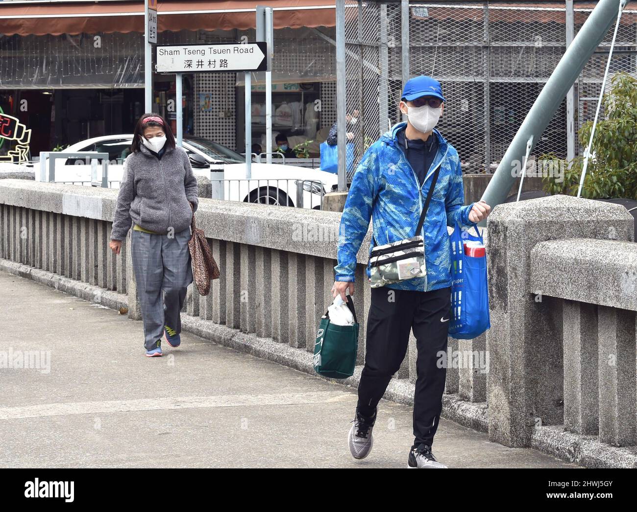 Hong Kong. 6th Mar 2022. Le persone che indossano maschere per il viso camminano su una strada nella Cina meridionale di Hong Kong, 6 marzo 2022. Credit: Lo Ping Fai/Xinhua/Alamy Live News Foto Stock