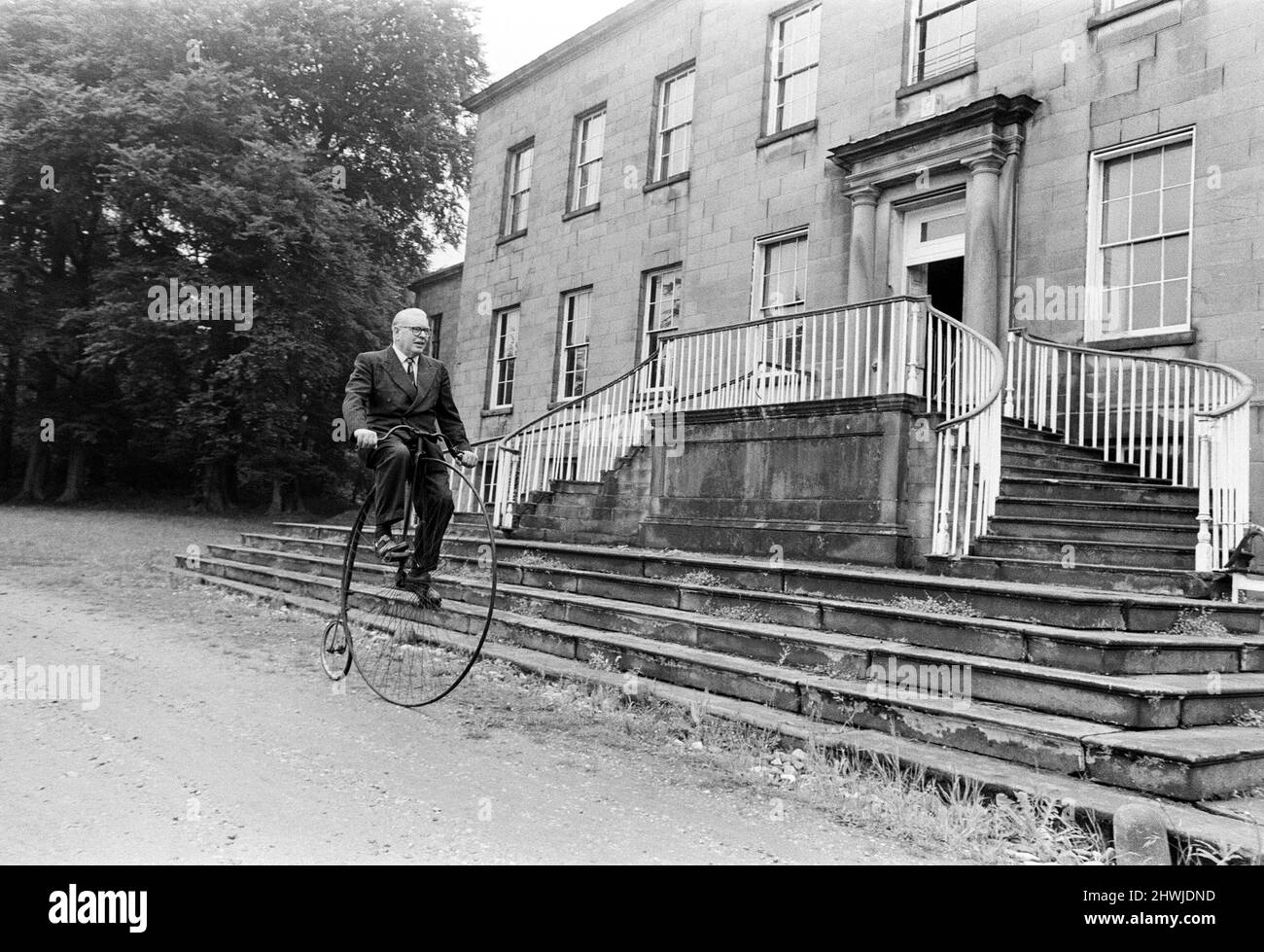 Il signor Philip Yorke fa un viaggio intorno ai giardini della sua casa su un Penny Farthing. Egli ha cercato di dare via la sua casa di famiglia per cinque anni, e ora il National Trust ha deciso di prendere la casa, piena di tesori inestimabili, tra cui il Penny Farthing, Erdigg Hall, Wrexham, Galles del Nord, 29th maggio 1973 Foto Stock