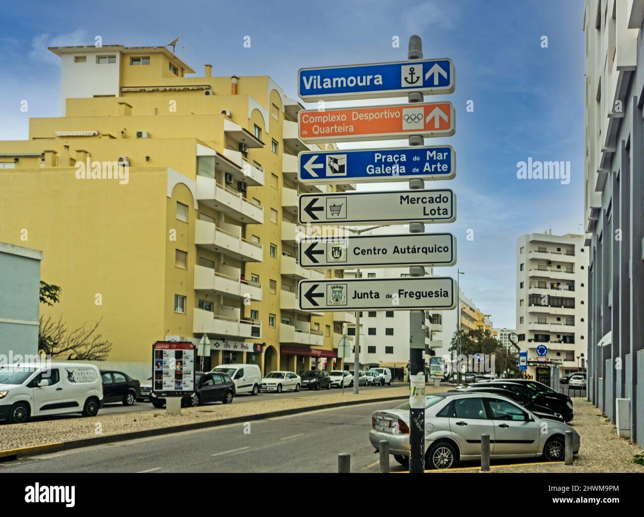 Un cartello stradale a Quarteira, Portogallo con indicazioni per Vilamoura e altri luoghi locali. Foto Stock