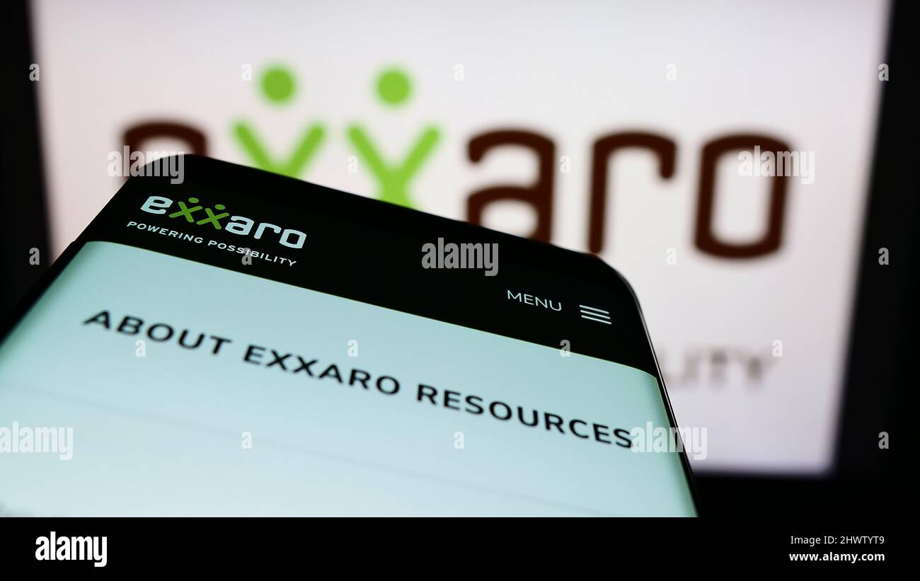 Smartphone con sito web della società sudafricana Exxaro Resources Limited sullo schermo di fronte al logo aziendale. Mettere a fuoco sulla parte superiore sinistra del display del telefono. Foto Stock
