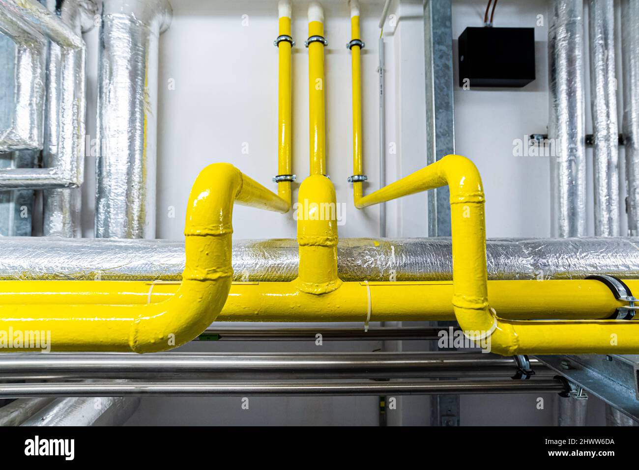 Gasdotti e gasdotti nei locali sotterranei della fabbrica, background industriale Foto Stock