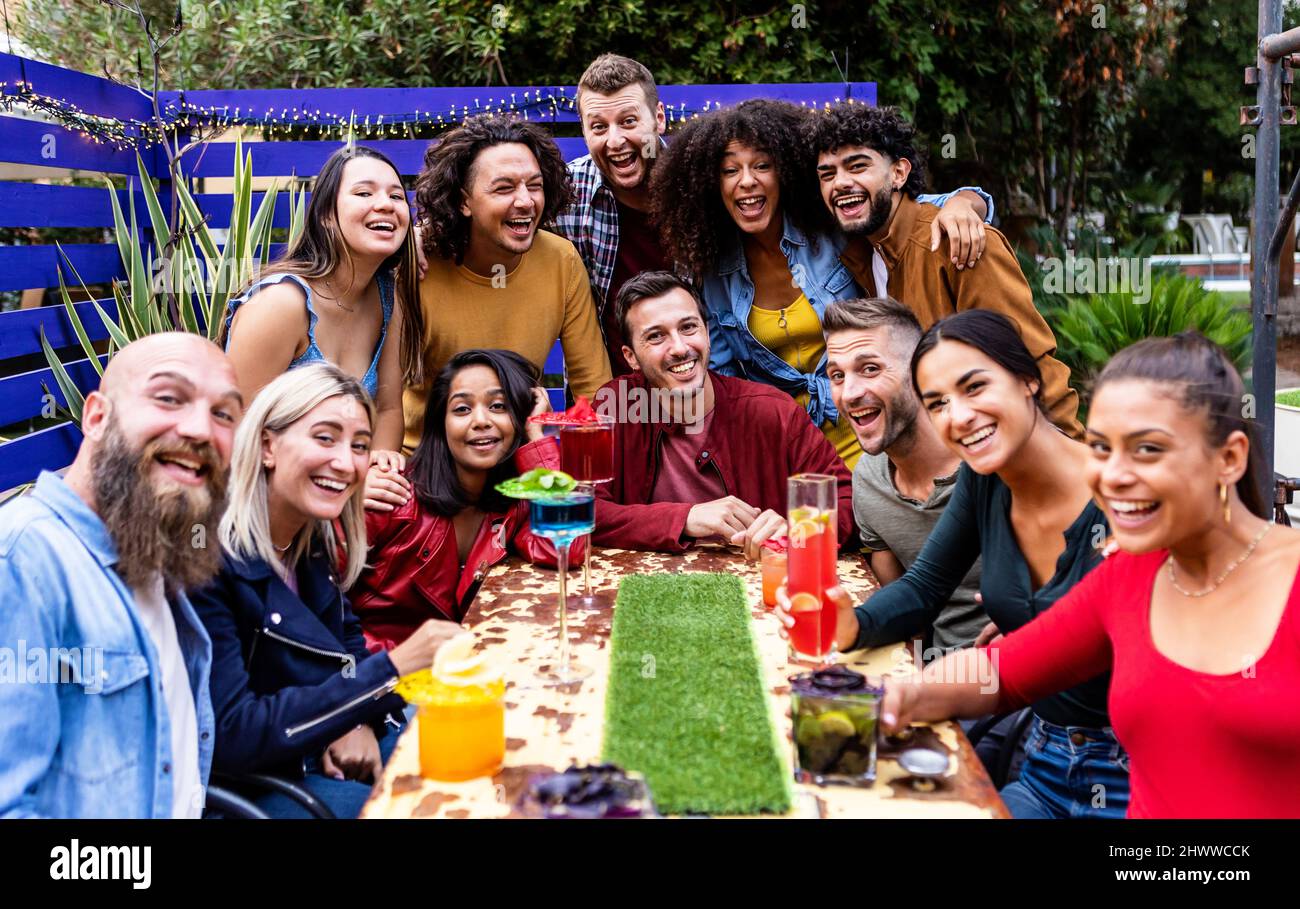 Gruppo internazionale Unito di giovani amici studenti che si divertono a bere insieme Foto Stock
