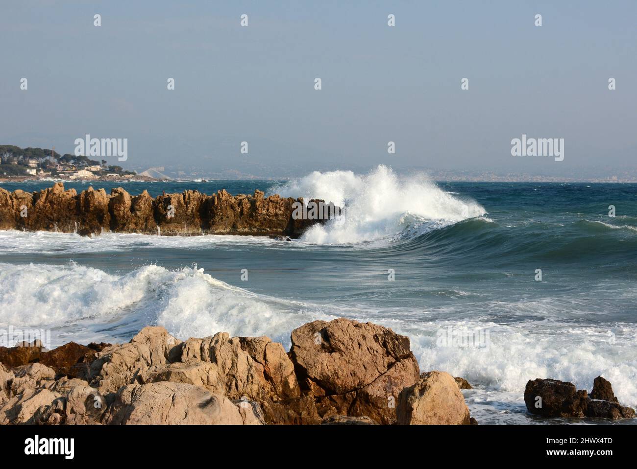 Francia, costa azzurra, Cap d'Antibes, la Garoupe, da un forte vento orientale onde potenti si infrangono sulle rocce. Foto Stock