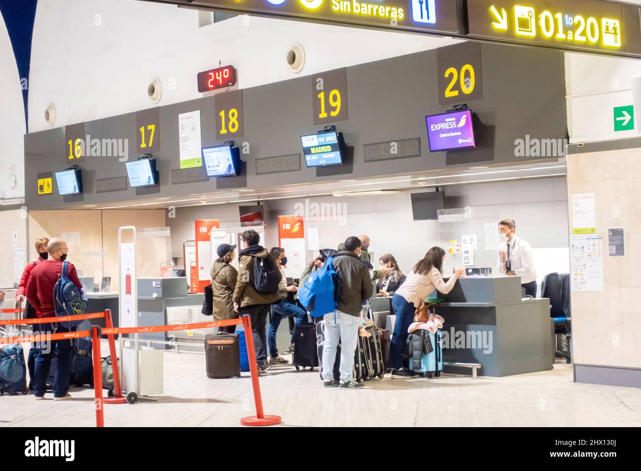 Passeggeri viaggiatori persone al check-in al terminal delle partenze all'interno dell'aeroporto di Siviglia, SVQ, Andalucia, Spagna Foto Stock