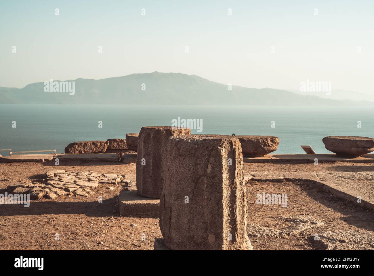 Le rovine dell'antica città di Assos, con il Mar Egeo e l'isola di Lesbo sullo sfondo. Ordine Dorico. Foto Stock