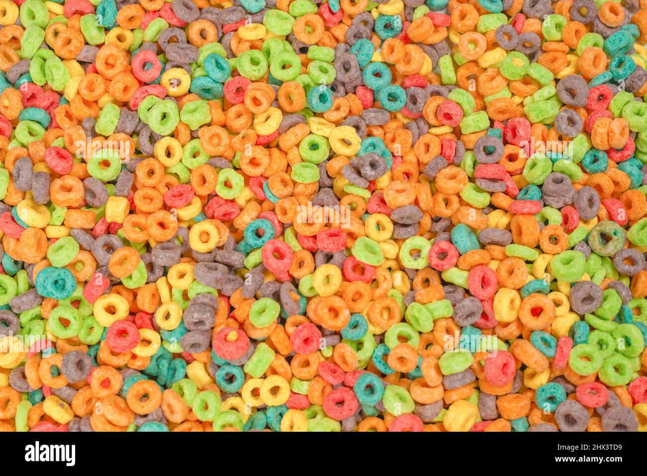 Dolci fiocchi multicolore, anelli di cereali come sfondo. Foto Stock