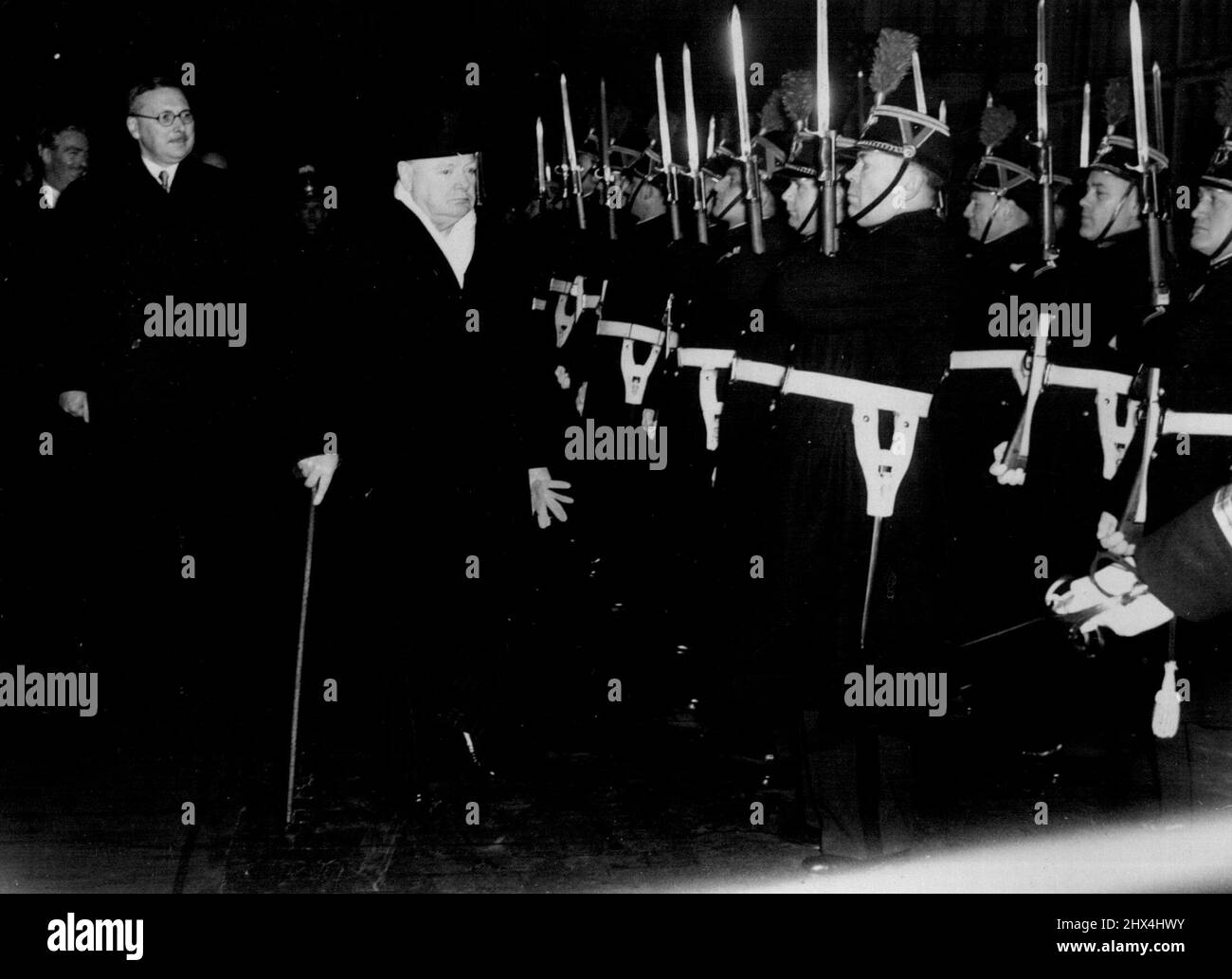 Churchill arriva a Parigi. Recensioni Honor Guard. Il primo ministro britannico Winston Churchill esamina la guardia d'onore alla stazione ferroviaria al suo arrivo qui. Sullo sfondo, da sinistra a destra, ci sono Sir Oliver Harvey, Ambasciatore britannico a Parigi, il Ministro degli Esteri britannico Anthony Eden e il Premier francese Rene Pleven. Eden accompagna Churchill nella sua visita a Parigi. Stanno tenendo colloqui con i ministri francesi in preparazione della prossima visita di Churchill a Truman, a Washington, il mese prossimo. Dicembre 18, 1951. Foto Stock