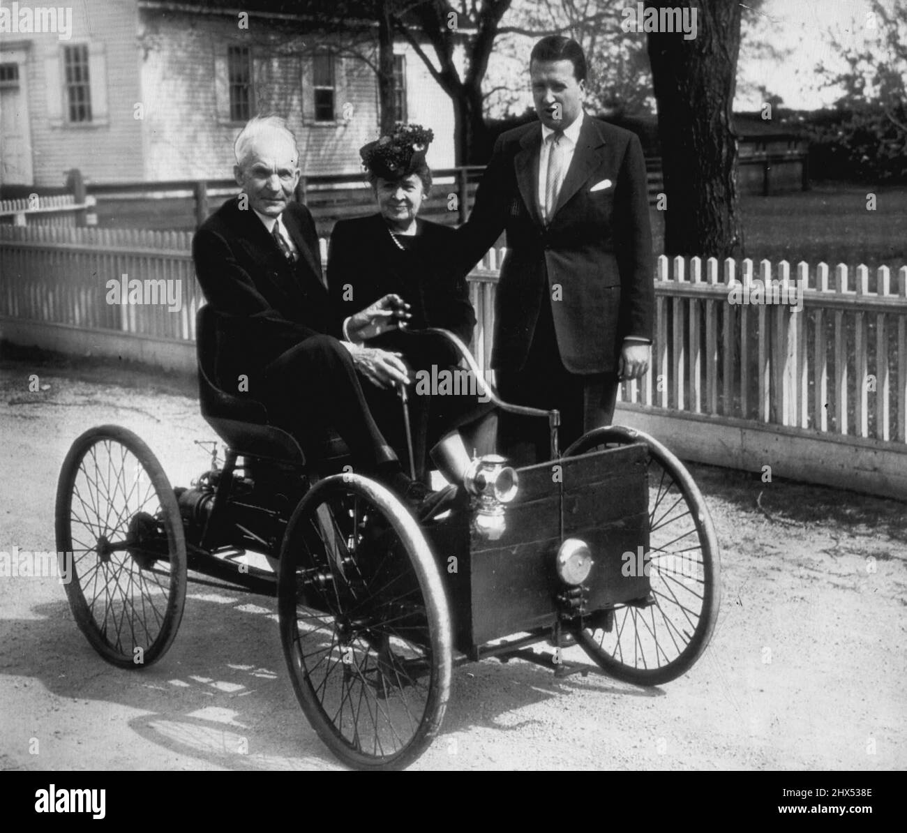 Ford corre nella sua prima auto -- seduto nella prima macchina che ha costruito (nel 1896) è Henry Ford fondatore della Ford Motor Co., che si prepara per la celebrazione del giubileo d'oro automobilistico di Detroit, che onorerà lui e altri pionieri auto. La signora Ford siede accanto a lui. A destra si trova Henry Ford II, presidente della Ford Motor Co. 25 maggio 1946. (Foto della stampante associata Wirephoto). Foto Stock