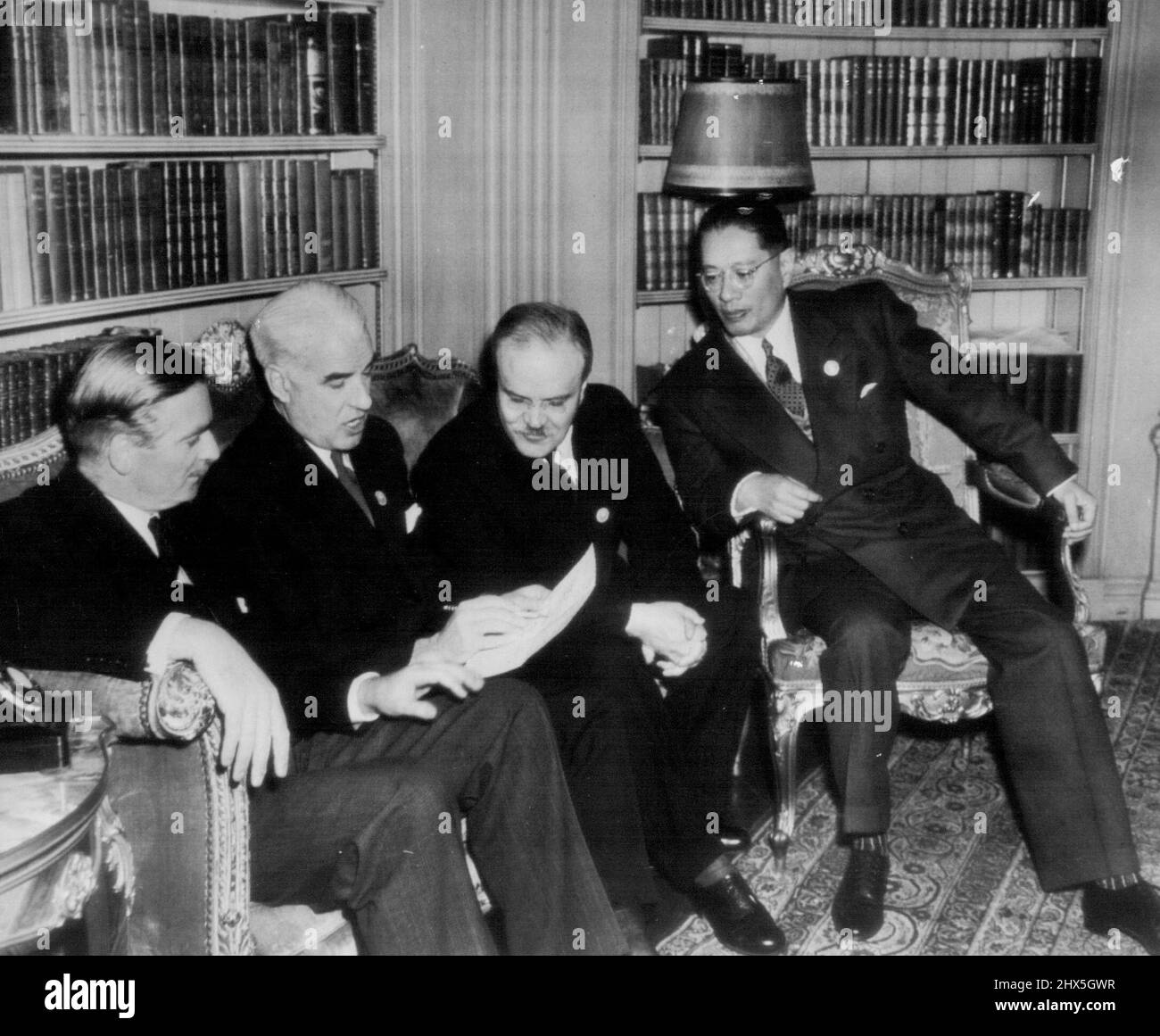 Big Four Gets Good News from Eisenhower - il Segretario di Stato Stettinius legge ai colleghi Ministri degli Esteri dei quattro grandi un messaggio appena ricevuto oggi dal Gen. Eisenhower annunciando le truppe tedesche in Olanda e la Danimarca si era arresa al campo Marshal Montgomery. Da sinistra a destra: Il ministro degli Esteri britannico Anthony Eden, il commissario degli Esteri sovietico V. M. Molotov, Stettinius, il ministro degli Esteri cinese T. V. Soong. Maggio 4, 1945. (Foto di AP Wirephoto). Foto Stock