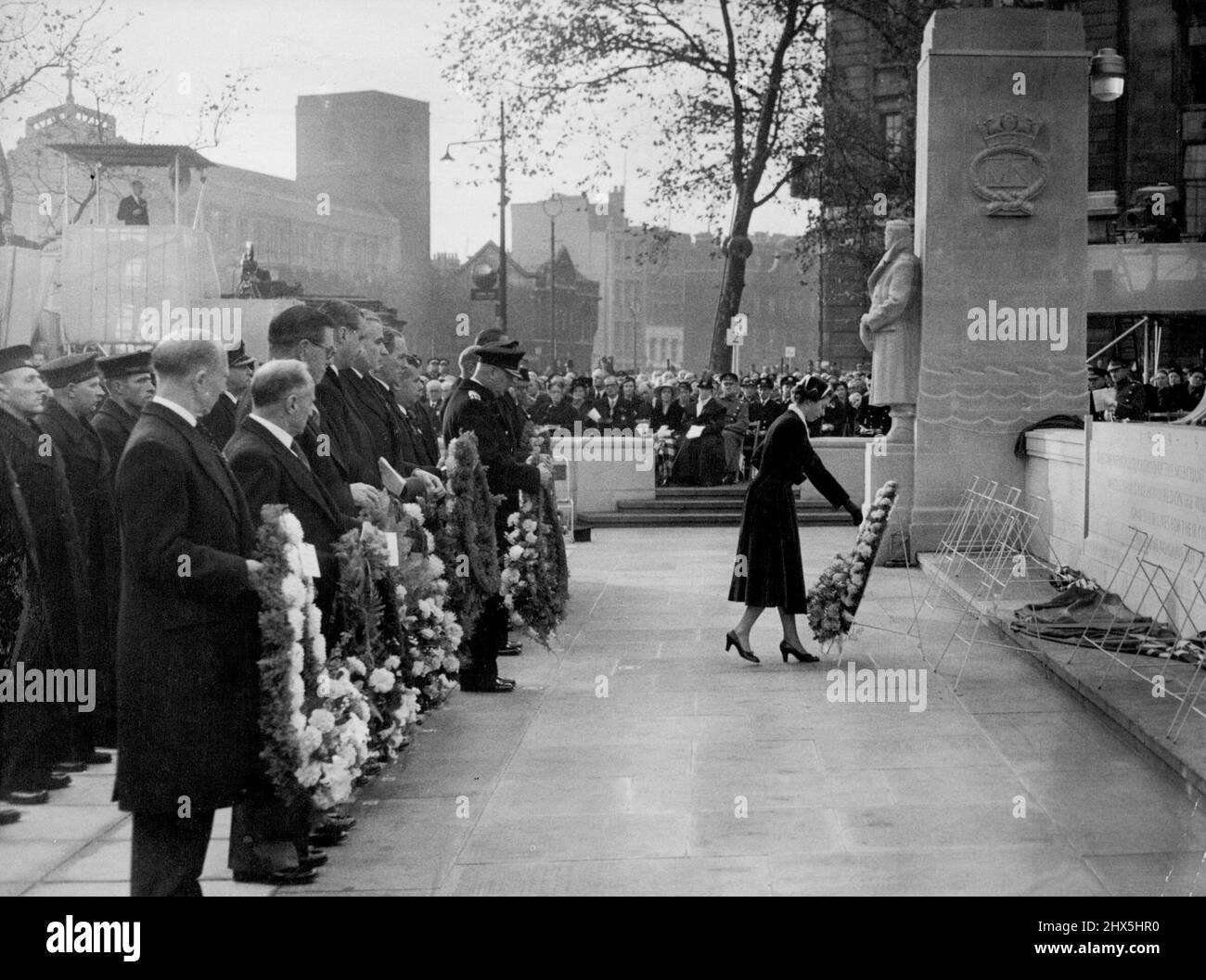 Queens Honors Merchant Navy War Dead. Dopo aver svelato l'esteso memoriale della marina mercantile sulla collina della torre, vicino alla torre di Londra, il 5 novembre, la regina vi depone una corona. I nuovi panel registrano i nomi di più di 24.000 uomini e donne della flotta marina mercantile e di pesca che hanno perso la vita nella seconda guerra mondiale e non hanno conosciuto tomba. l'arcivescovo di Canterbury dedicò il memoriale e furono deposte 18 corone, le prime tre dalla Regina, dal Duca di Edimburgo e dal Duca di Gloucester. Ottobre 15, 1955. (Foto di stampa associata). Foto Stock