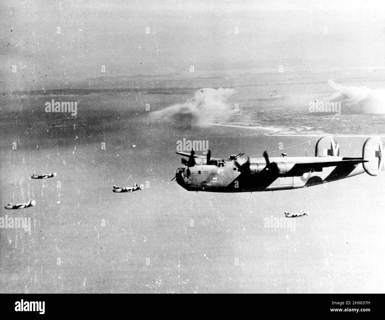 Invasione di Ramree Island. Sei del R.A.F. Liberatore che ha contribuito a saltare fuori le posizioni giapponesi sono visti lasciare l'isola di Ramree dopo aver fatto il loro attacco. Sull'isola si possono vedere nubi di fumo. A sostegno del terzo attacco aereo, terrestre e marittimo su larga scala o della costa occidentale della Birmania, R.A.F. Leviti di fissaggio. Spitfun, Beaufighters, e U.S.A.A.F. P-38 del R.A.F. Arakan Group e liberatori della Strategic Air Force, molti dei quali sono stati volati dagli australiani, e U.S.A.A.F. B-24' Foto Stock