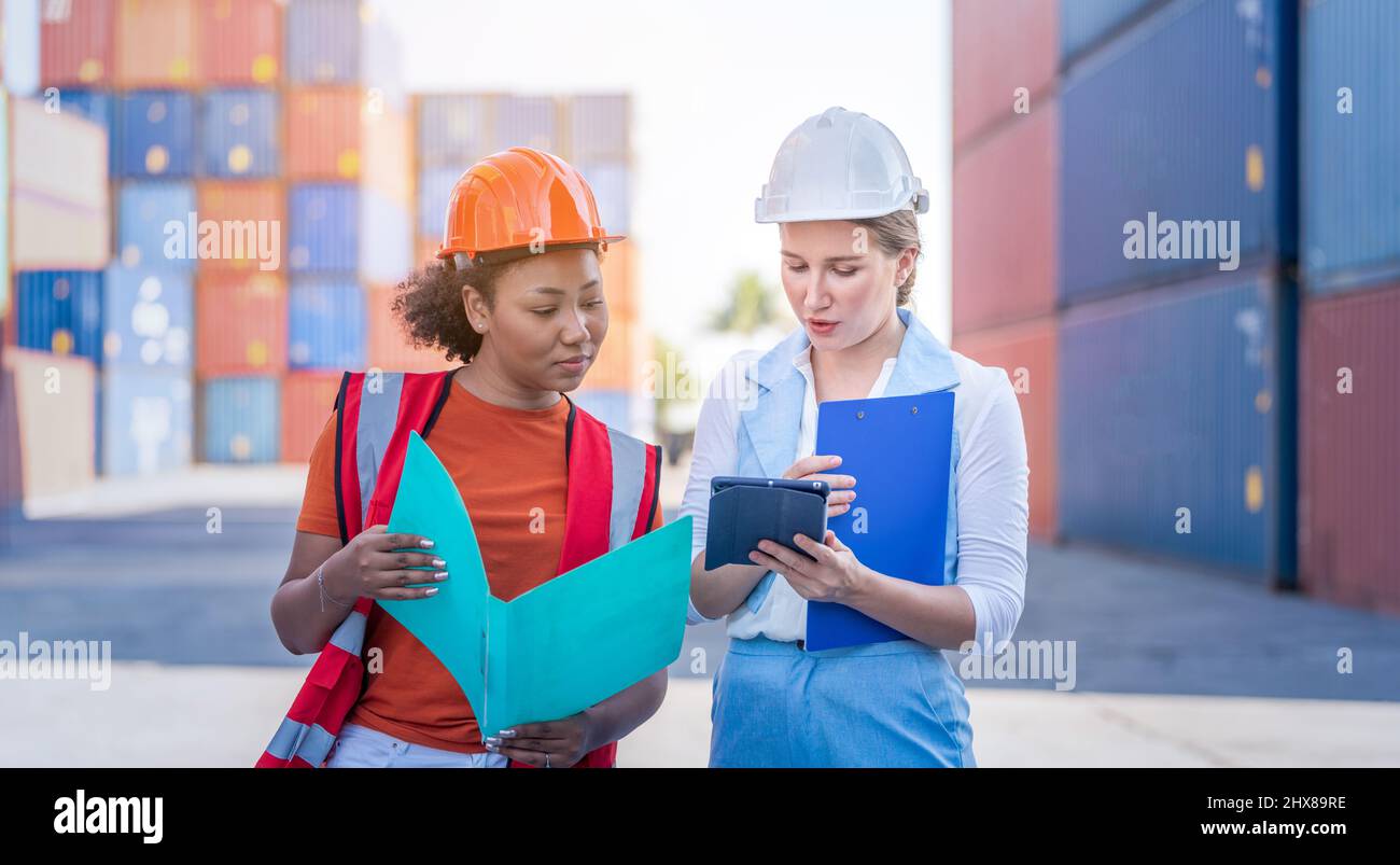 African american holding board file e report business logistic a Woman CEO in cargo container warehouse import and export Foto Stock