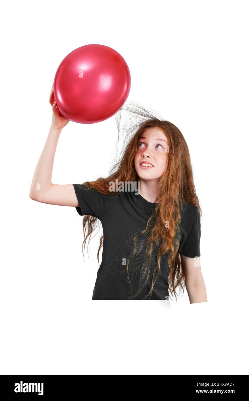 Strofinare i capelli o contro un palloncino Foto Stock