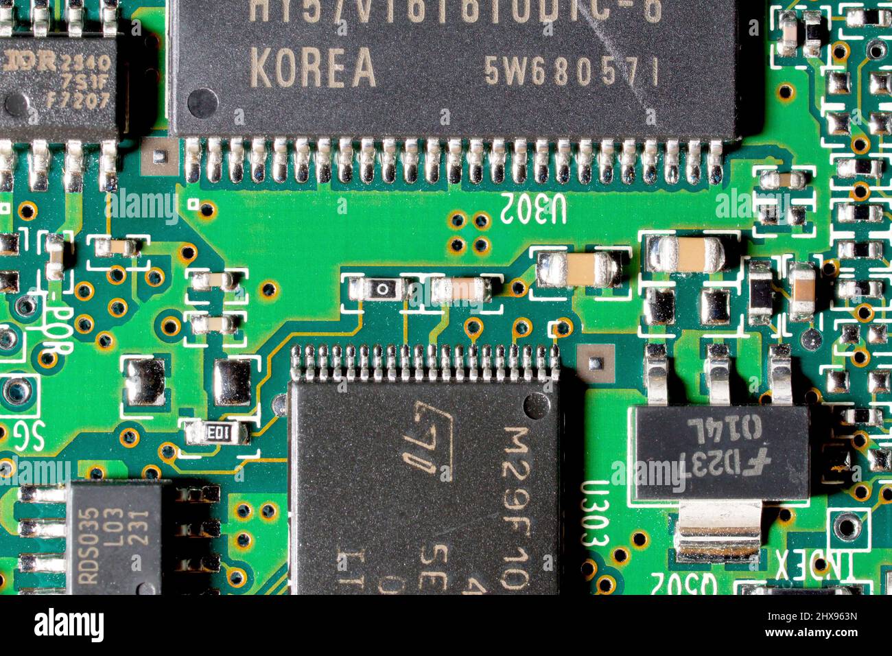 Primo piano di un circuito stampato di un computer, che mostra varie dimensioni di chip integrati e altri componenti elettronici. Foto Stock