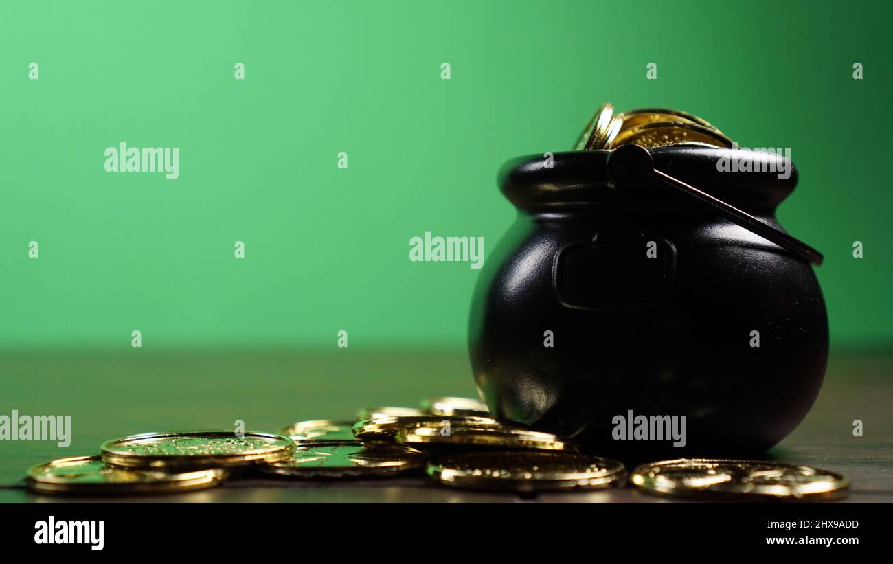 Vaso d'oro di fronte a sfondo verde per il modello del giorno di San Patrizio. Foto Stock