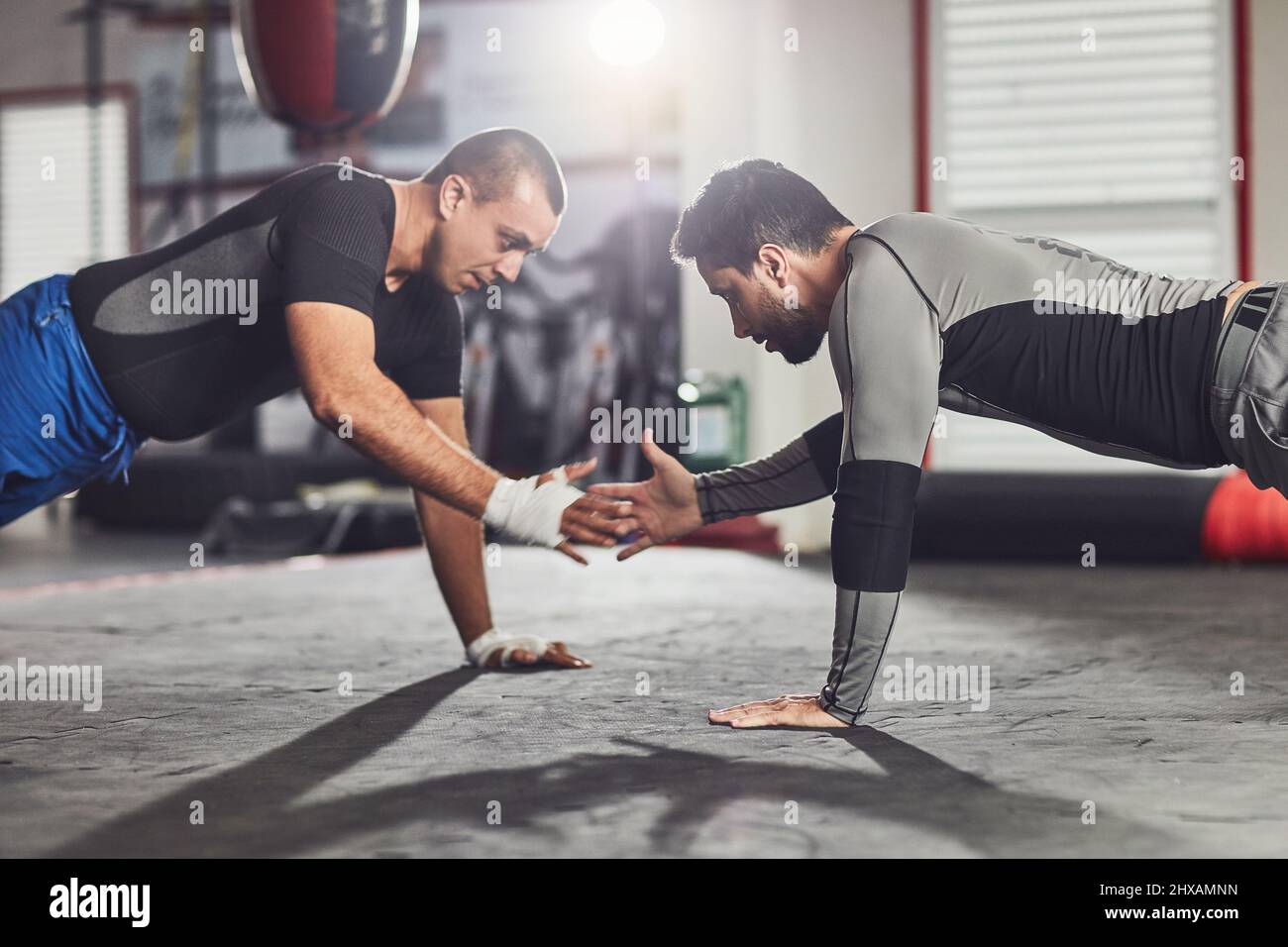 Sportività soprattutto. Scatto corto di due combattenti professionisti che sparano in palestra. Foto Stock