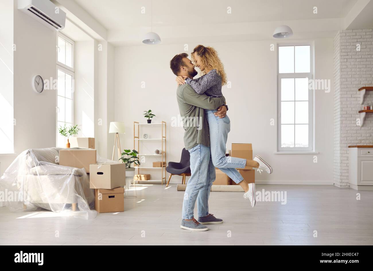 Felice coppia abbraccio celebrare il trasferimento a casa propria Foto Stock