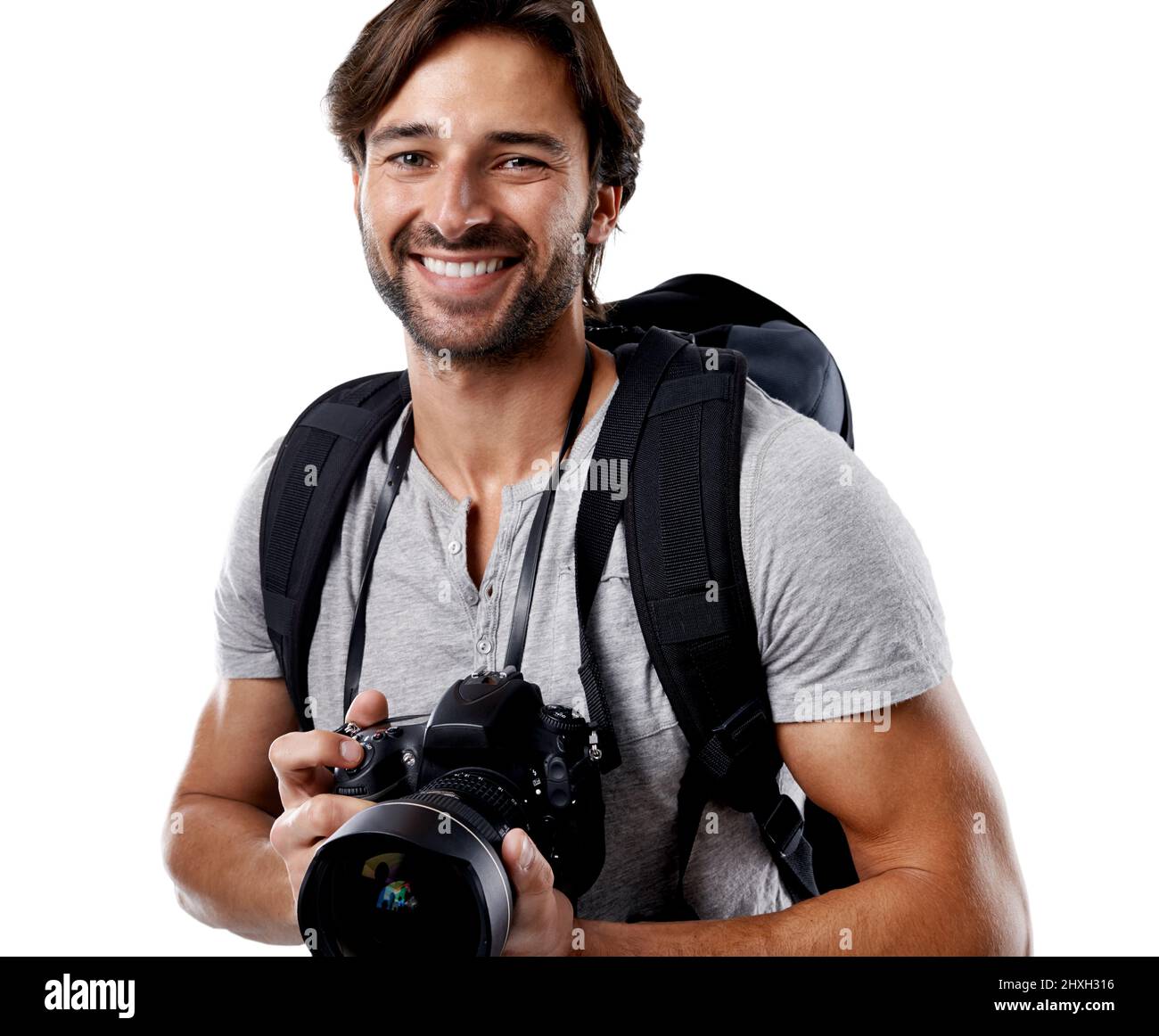 Tutto ciò di cui avete bisogno è l'attrezzatura giusta. Un bel fotografo sorridente alla fotocamera. Foto Stock