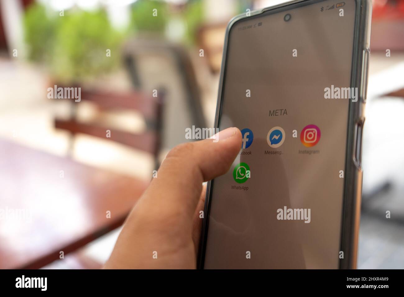 Primo piano di una mano che controlla le sue app Meta, Facebook, Instagram, Whatsapp e Messenger Foto Stock