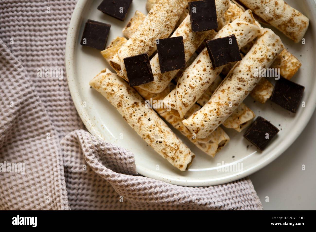 Pancake con cioccolato su un piatto grande. Tante deliziose pinzette Foto Stock
