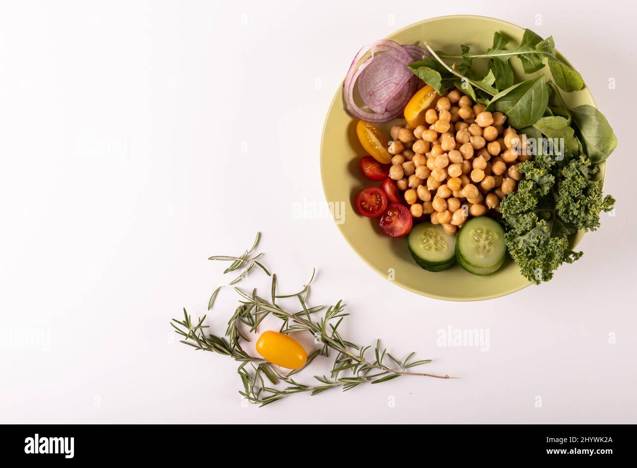 Direttamente sopra shot di cibo sano fresco in ciotola da erbe su sfondo bianco, copia spazio Foto Stock