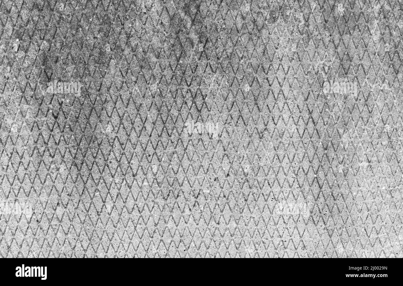 Vecchio muro di cemento grigio con intaglio a forma di diamante, fondo piatto foto texture Foto Stock