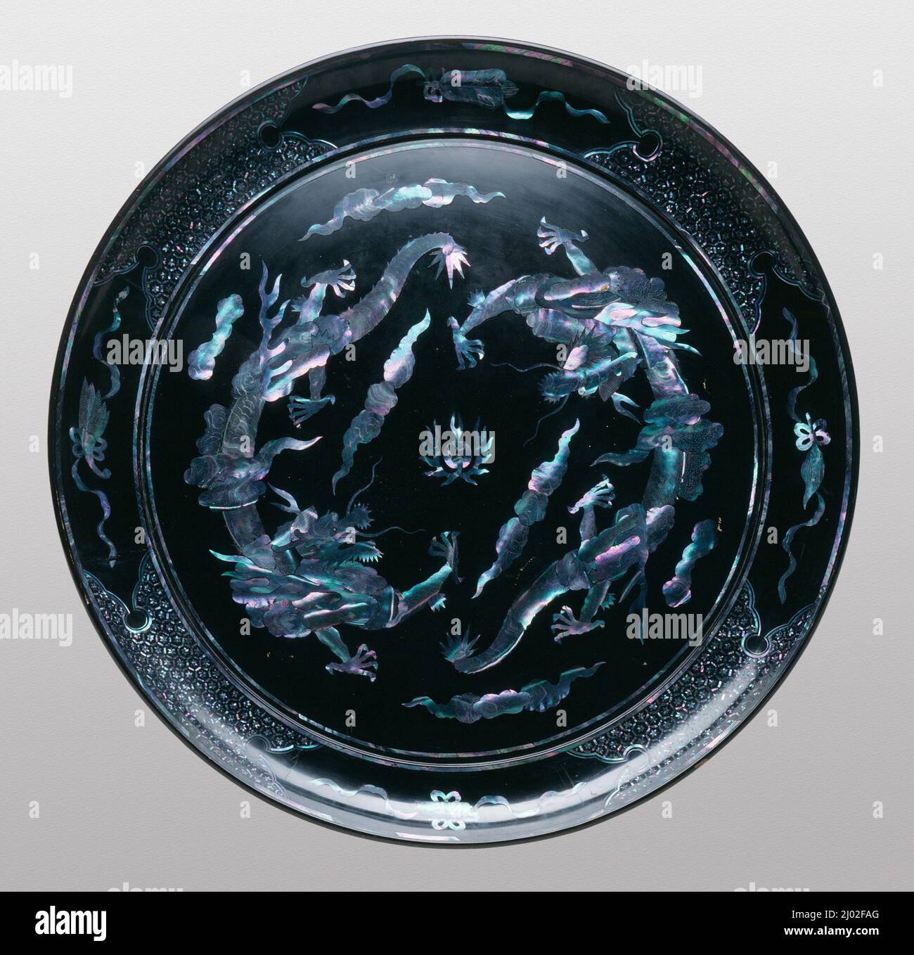 Vassoio circolare con due draghi che inseguono una perla fiammeggiante. Isole Ryukyu, circa 1700-1800. Mobili; Serviceware. Lacca nera su anima in legno con inserto madreperla Foto Stock