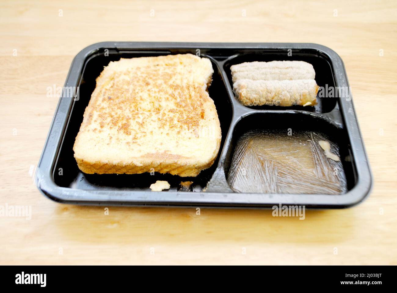 Microonde surgelato precotto colazione di toast alla francese, sciroppo d'acero e salsicce Foto Stock