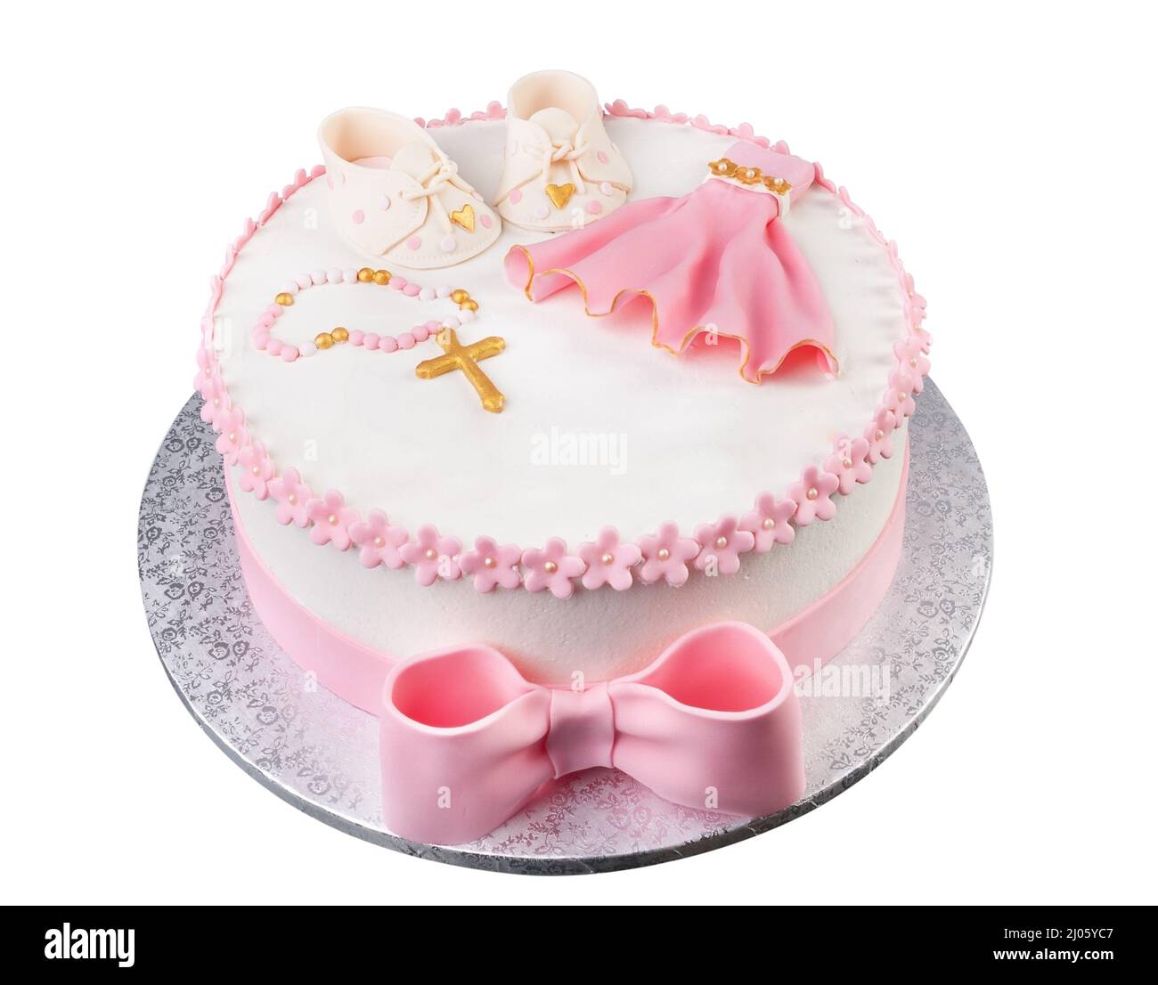 Una torta rosa creativa con un abito a croce e stivali per una bambina di battesimo. Primo piano dall'alto. Foto Stock